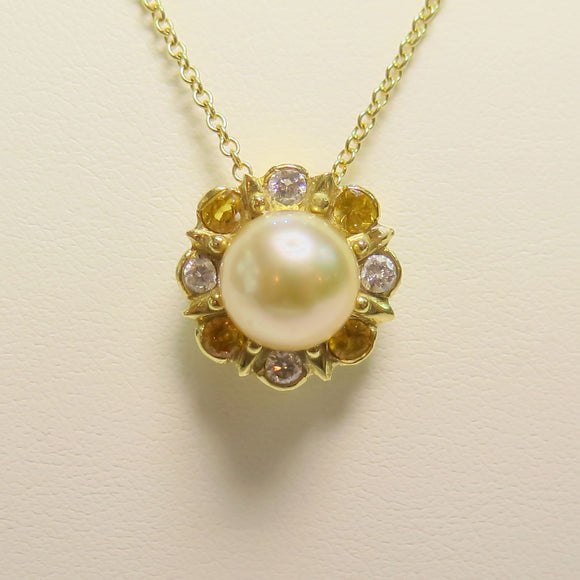 custom south sea pearl pendant with a yellow sapphire and diamond halo